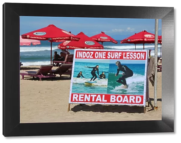 Surf lesson and board rental sign, tourist activities on Legian Beach, Denpasar, Bali, Indonesia