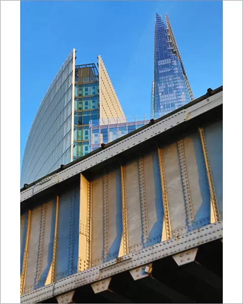 The Shard building and metal railway bridge in London, England