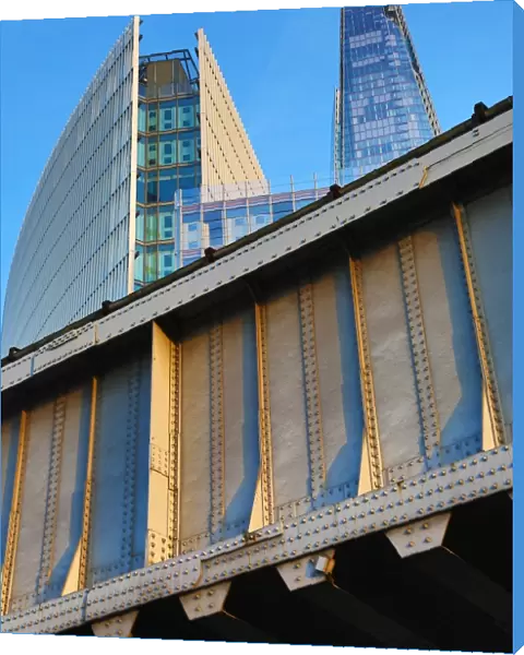 The Shard building and metal railway bridge in London, England