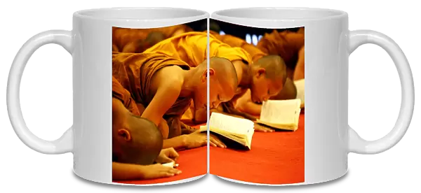 Buddhist monks praying at Wat Chedi Luang in Chiang Mai, Thailand