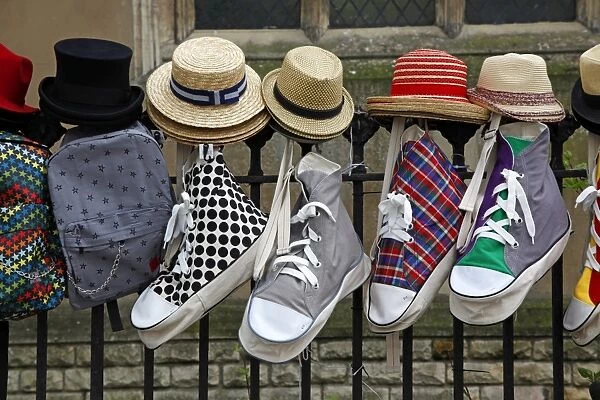 Show bags and hats hanging on railings in Cambridge