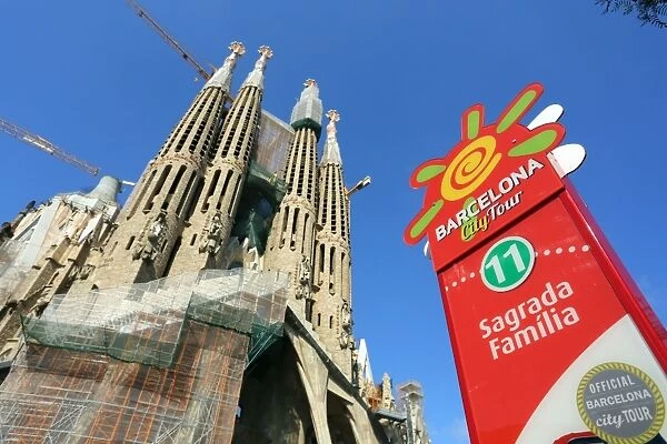 Barcelona City Tour bus stop sign for tourists at the Basilica de la Sagrada Familia cathedral in Barcelona, Spain