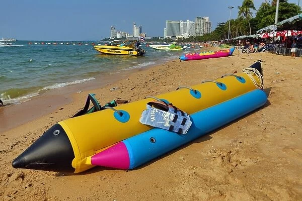 Beach scene with an inflatable banana boat on the seafront of Pattaya, Thailand