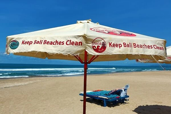 Beach umbrellas and deckchairs on Legian Beach, Denpasar, Bali, Indonesia