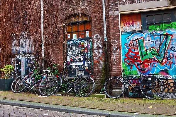 Bicycle and colourful graffiti street scene in Amsterdam, Holland
