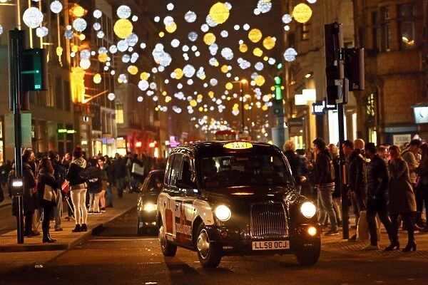 Black taxi cab and Oxford Street Christmas lights in London