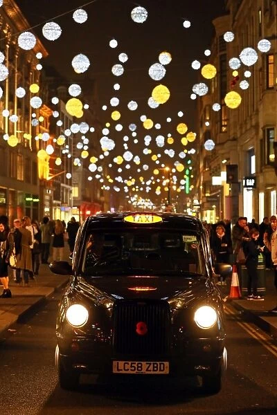 Black taxi cab with Oxford Street Christmas lights in London