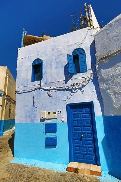 Blue and white walls of buildings in the Kasbah of the Udayas in Rabat, Morocco