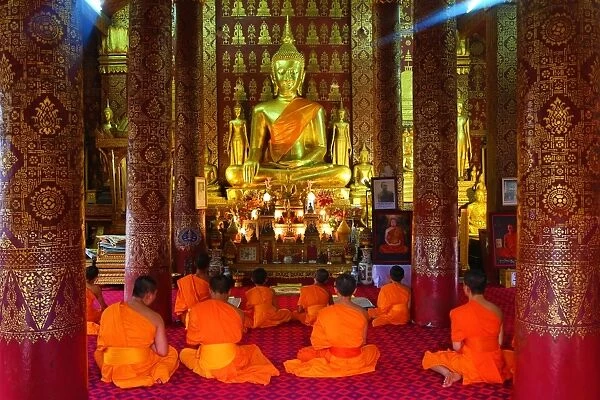 Buddhist monks at worship in Wat Sen temple in Luang Prabang, Laos