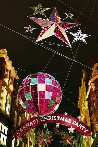 Carnaby Street Christmas Decorations shaped like balls and stars in London, England