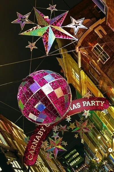 Carnaby Street Christmas Decorations shaped like balls and stars in London, England