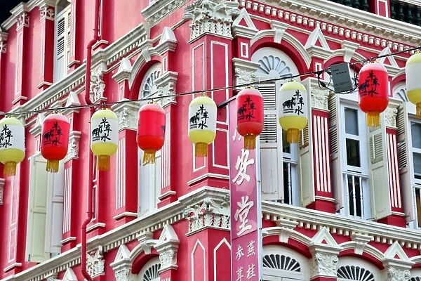 Chinese lanterns hanging in front of colourful buildings with shutters and windows in Chinatown in Singapore, Republic of Singapore