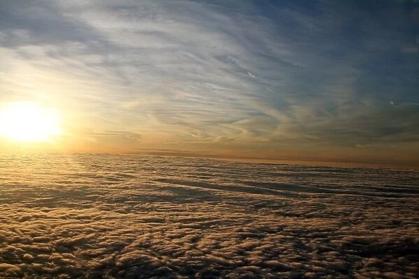 Clouds at sunset. Aerial view of the sky from above the clouds at sunset