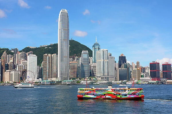 Colourful Ferry crossing Victoria Harbour and Skyline, Hong Kong, China