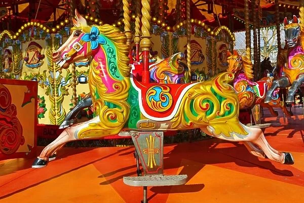 Colourful painted horses on a fairground carousel
