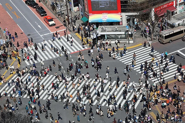 Crowds crossing the Shibuya pedestrian crossing in Shibuya, Tokyo, Japan
