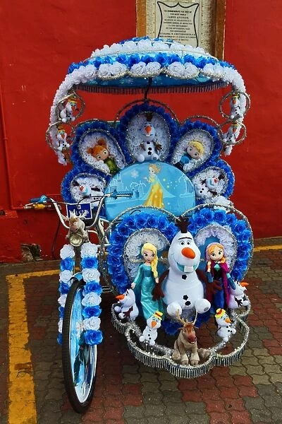 Decorated kitsch cycle trishaw rickshaw with soft toys in Malacca, Malaysia