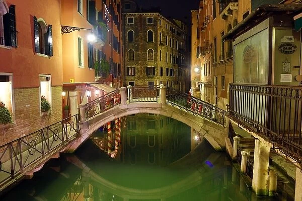 Deserted bridge over a canal at night in Venice, Italy