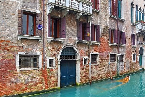 Doorway of a building on a canal in Venice, Italy