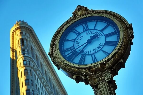 The Flatiron Building, originally the Fuller Building, and Fifth Avenue Building clock at Fifth Avenue and Madison Square, New York. America