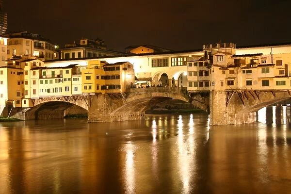 Florence, Italy. Ponte Vecchio bridge on the Arno River at night, Florence, Italy