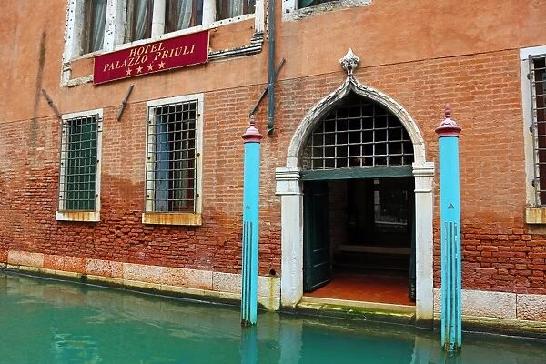 Gateway in a wall on a building on a canal in Venice, Italy