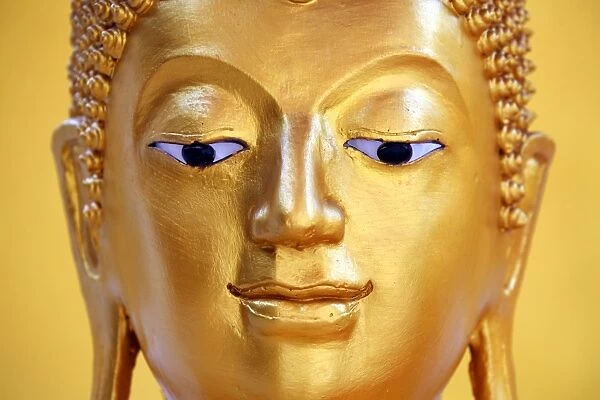 Gold Buddha statue head and face at Wat Panping Temple in Chiang Mai, Thailand