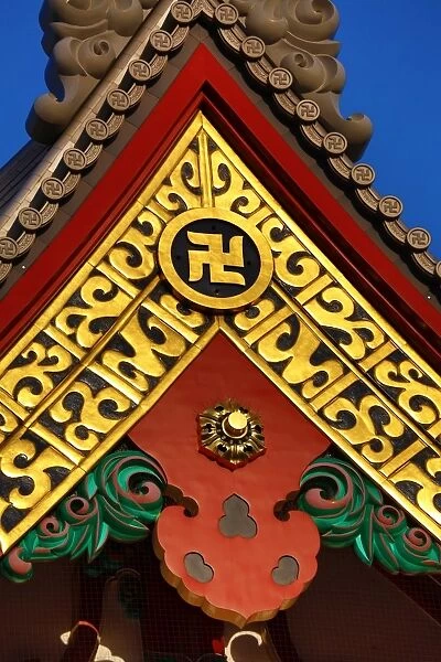 Gold Buddhist cross symbol on a giant vase at the Sensoji Asakusa Kannon Temple, Tokyo, Japan