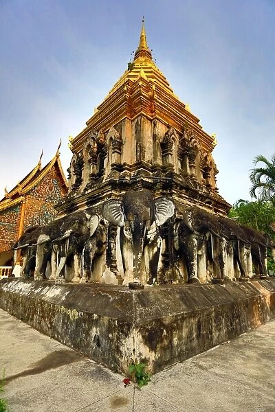 Gold chedi decorated with elephants in Wat Chiang Man Temple in Chiang Mai, Thailand