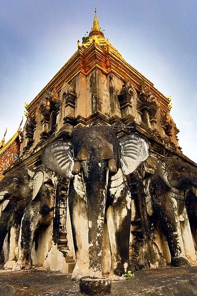 Gold chedi decorated with elephants in Wat Chiang Man Temple in Chiang Mai, Thailand