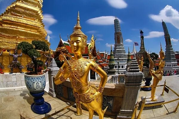 Gold Kinnara Statue at Wat Phra Kaew Temple complex of the Temple of the Emerald Buddha in Bangkok, Thailand