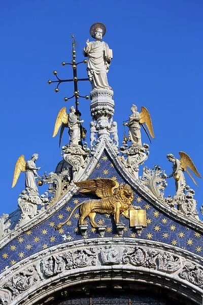 Gold winged lion of St. Mark on the Basilica di San Marco, Cathedral of St. Mark, in Saint Marks Square (Piazza), in Venice, Italy