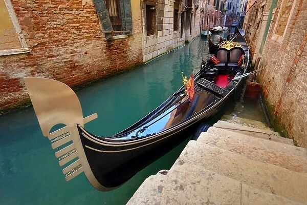 Gondola moored in a canal, in Venice, Italy