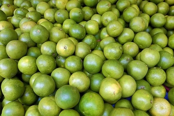 Green grapefruit or pummelos on sale in a street market in Chinatown in Singapore, Republic of Singapore