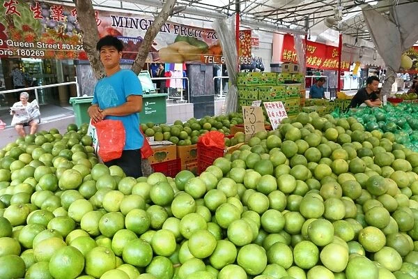 Green grapefruit or pummelos on sale in a street market in Chinatown in Singapore, Republic of Singapore