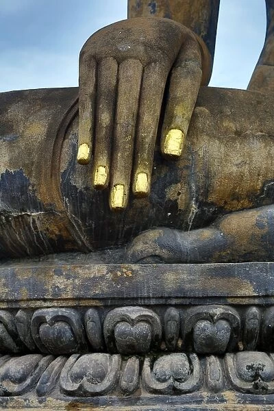 Hand on a Buddha statue at Wat Mahathat temple, Sukhotai, Thailand
