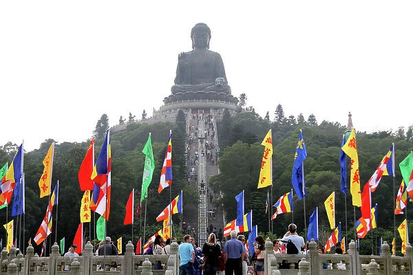 Hong Kong, China. Flags and the Tian Tan Big Buddha statue on Lantau Island in Hong Kong