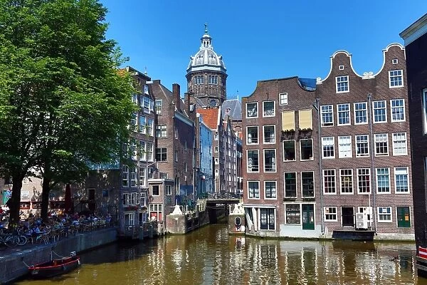 Houses on the Oudezijds Kolk Canal and the Basilica of Saint Nicholas in Amsterdam
