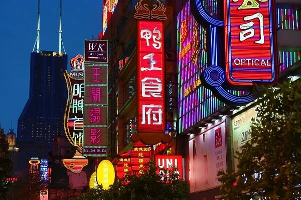 Illuminated Chinese shop signs at night along East Nanjing Road, Shanghai, China
