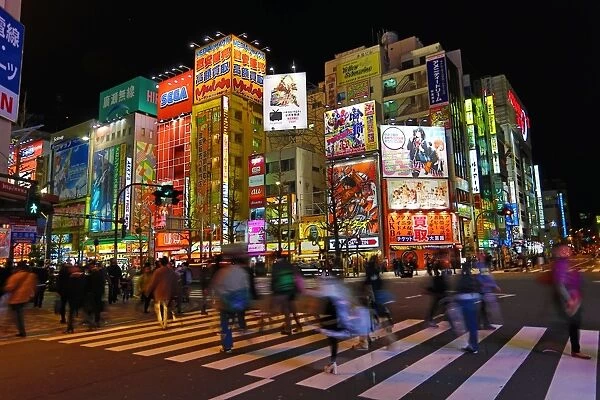 Lights of shops and buildings of Akihabara Electric Town street scene with a pedestrian crossing in Tokyo, Japan