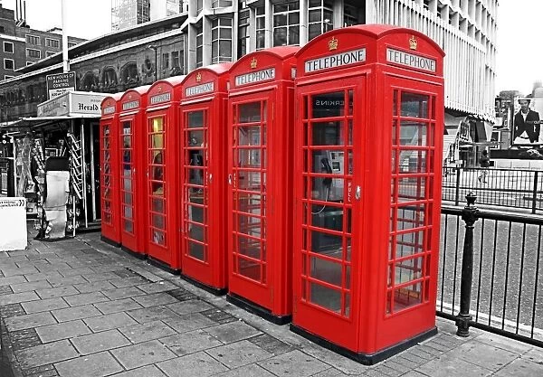 Line of red telephone boxes in London, England, spot colour