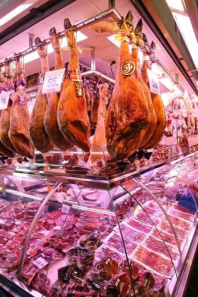 Meat and butcher stalls and fresh produce at La Boqueria market de St Josep, Barcelona, Spain