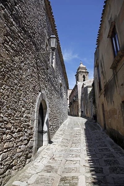 Narrow alley and stone walled street in Erice, Sicily, Italy