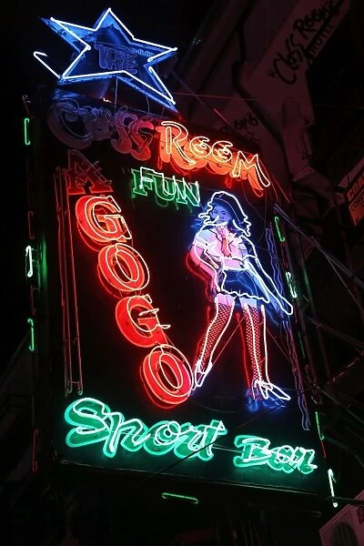 Night scene of illuminated neon signs of a Gogo Bar in Boyz Town in the Red Light District of Pattaya, Thailand