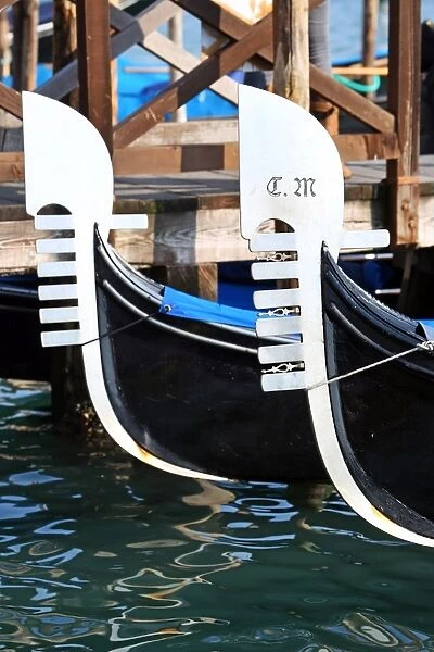 Prows of moored gondolas in Venice, Italy
