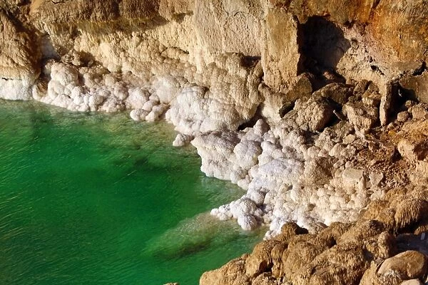 Salt deposits on the rocky shoreline of the Dead Sea, Jordan