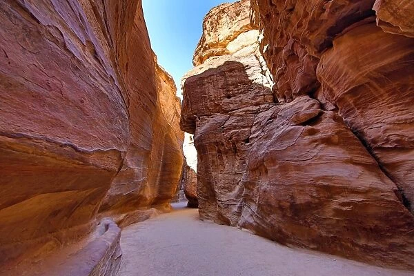 Sandstone cliiffs of the Siq canyon entrance to the city of Petra, Jordan