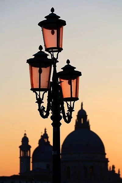 Santa Maria Della Salute and a lamp post at sunset in Venice, Italy