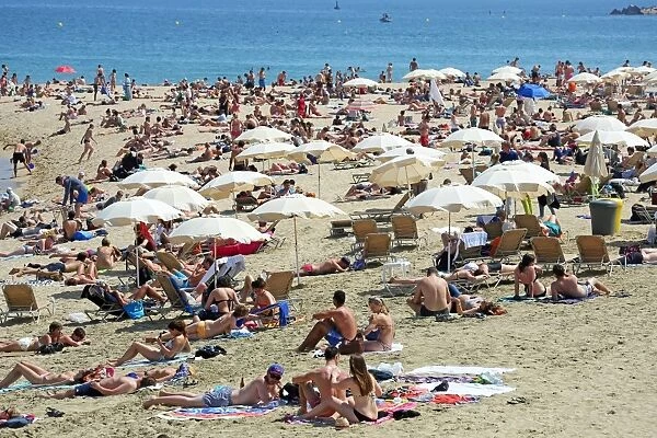 Scene of holiday crowds on the crowded beach, Barcelona, Spain