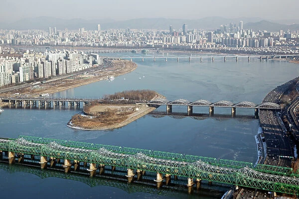 Seoul, South Korea. The Han River and bridges with the city skyline in Seoul, South Korea